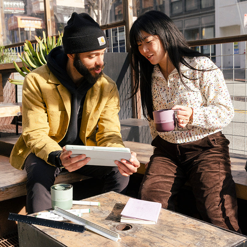 12oz-rise-mug-w0 12oz_rise_coffee_mug_dusty_orchid_couple_city_patio_square.jpg