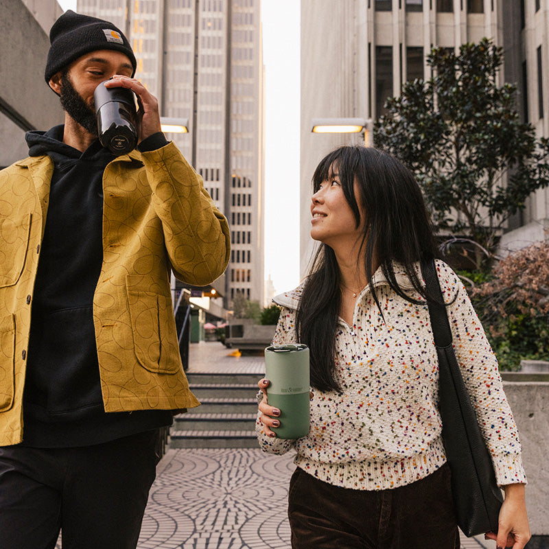 16oz-rise-tumbler-e3 16oz_rise_tumbler_black_iceberg_couple_drink_city_street_square.jpg