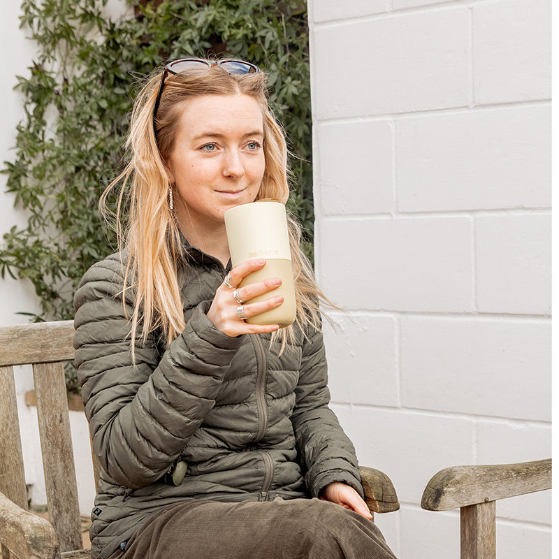 16oz-rise-tumbler-e3 16oz_rise_tumbler_wax_yellow_woman_seat_outside_square.jpg
