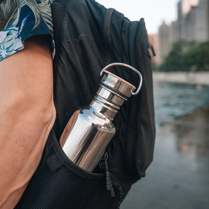 27oz-reflect-with-bamboo-cap-k0 K27SSLRF-MS-BAMBOO_reflect-bottle_backpack_lifestyle.jpg